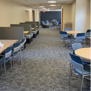 Student lounge with tables and comfortable chairs