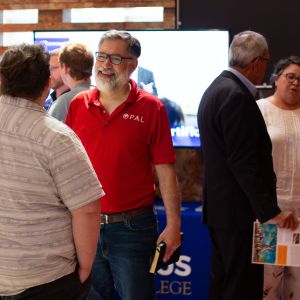 People talking at conference booths