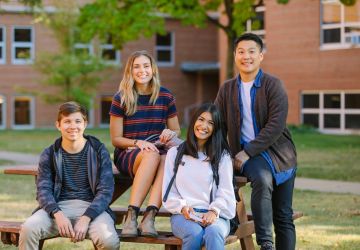 students sitting together on a picnic table