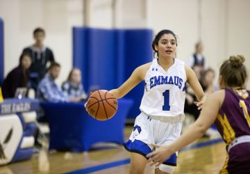 Female Dribbling Basketball in Emmaus Eagles Jersey