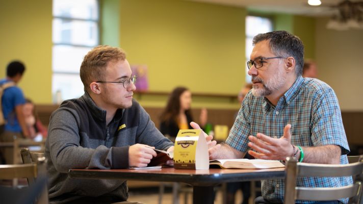 Emmaus student and faculty talking in the Coffee Shop