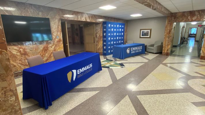 Lobby with long tables with blue table cloths