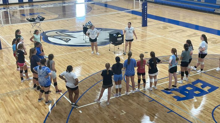 High School girls receive volleyball instruction